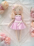 Handmade blonde rag doll wearing a pink gingham dress with a Peter Pan collar