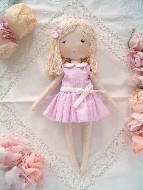 Handmade blonde rag doll wearing a pink gingham dress with a Peter Pan collar